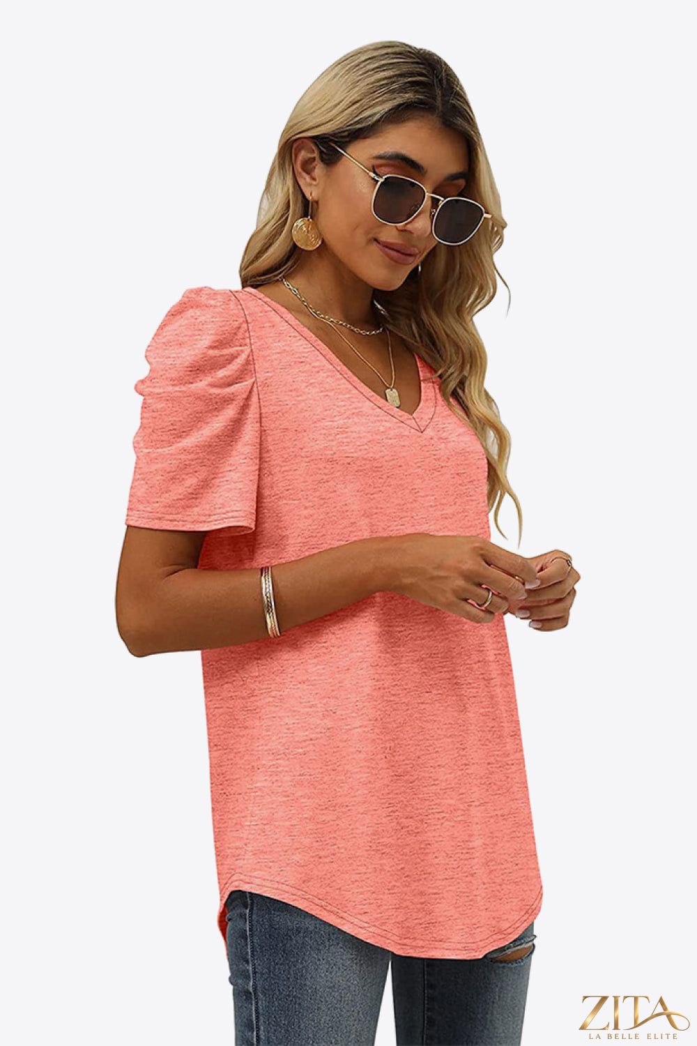 V-neck puff sleeve tee by Trendsi, featuring a fitted bodice and soft fabric with stylish puffed sleeves and a V-neckline.