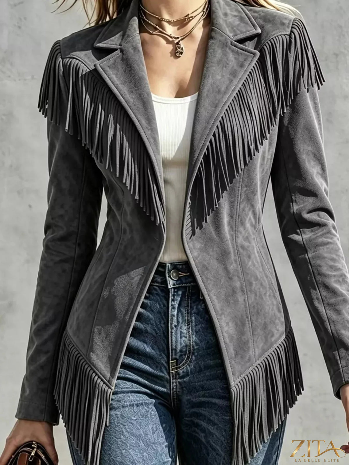 Western-inspired fringed open front jacket by Trendsi, featuring leather-like material and detailed fringe accents.