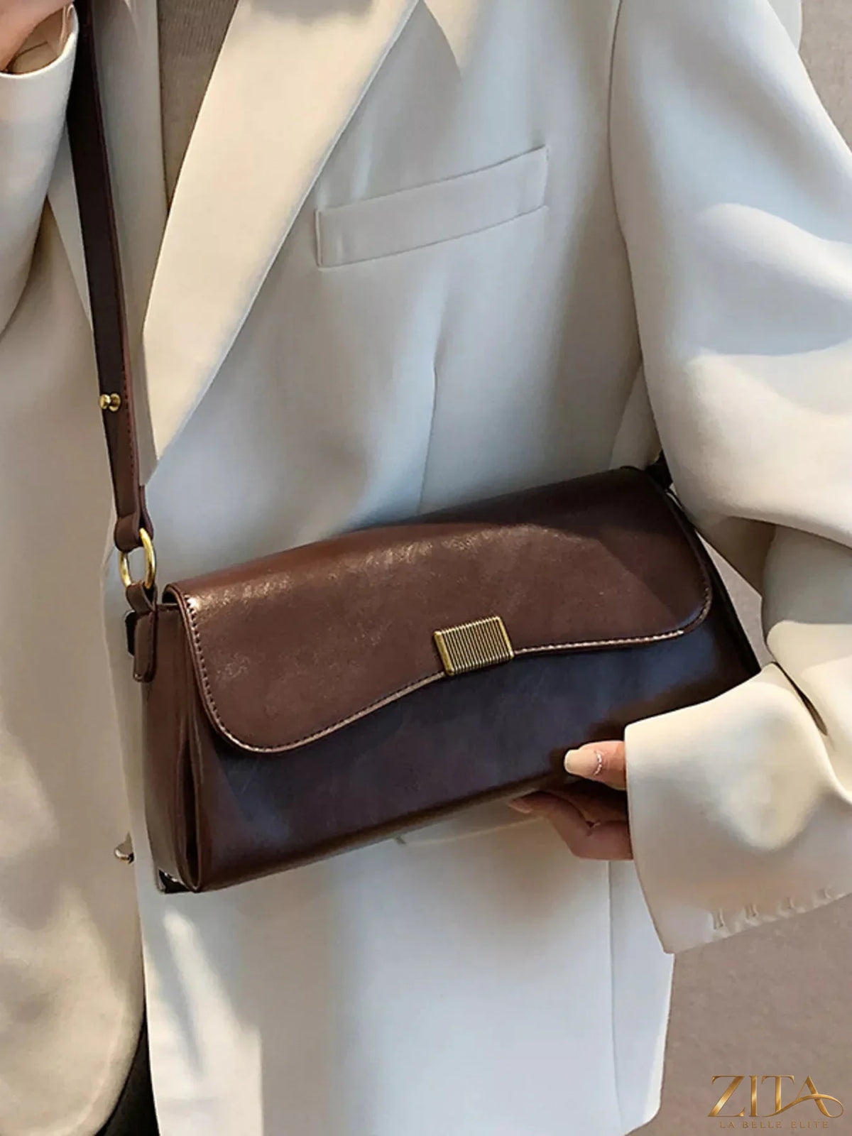 Leather Flap Shoulder Bag by Trendsi featuring a sleek design, adjustable strap, and classic flap closure in rich leather.