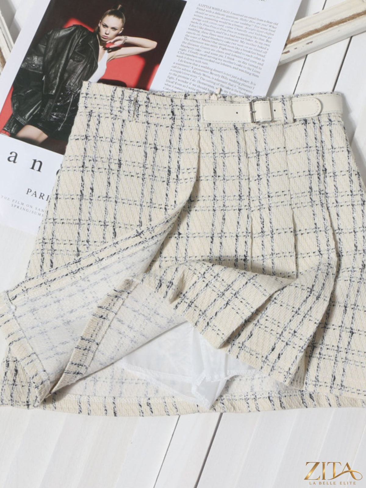 Zita La Belle Elite pleated plaid mini skirt showing a high-waisted design with green, black, and red tartan pattern.
