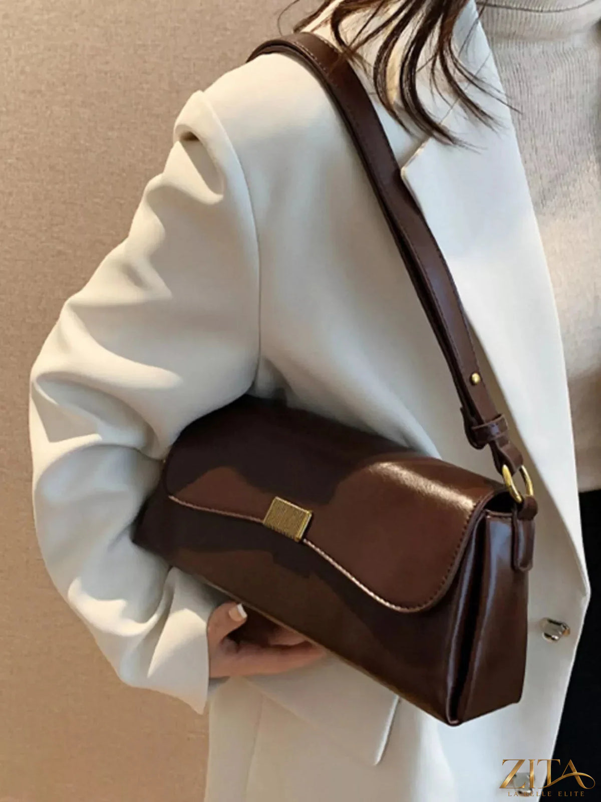 Leather flap shoulder bag with adjustable strap and minimalist design, featuring a sleek, stylish look for casual and everyday use.