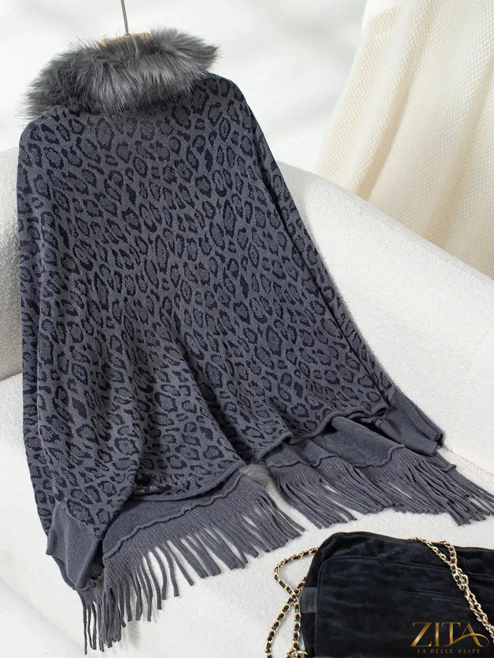 Leopard print fringe open front long sleeve poncho by Trendsi, featuring a stylish animal pattern and flowing fringe details.