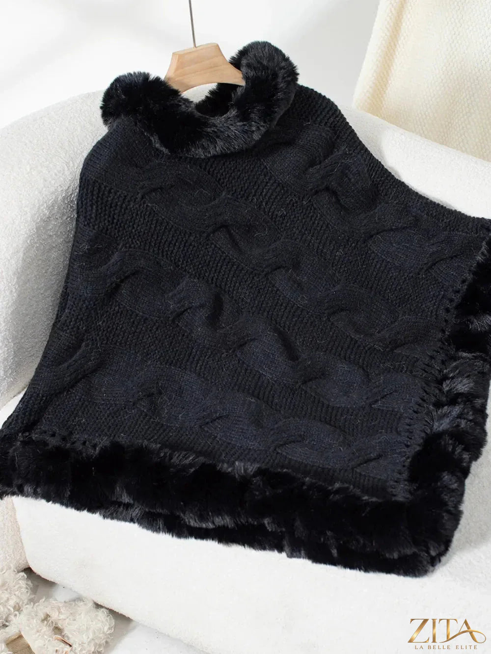 Fuzzy hem cable-knit poncho in soft, cozy fabric, featuring a relaxed fit and stylish cable-knit pattern.