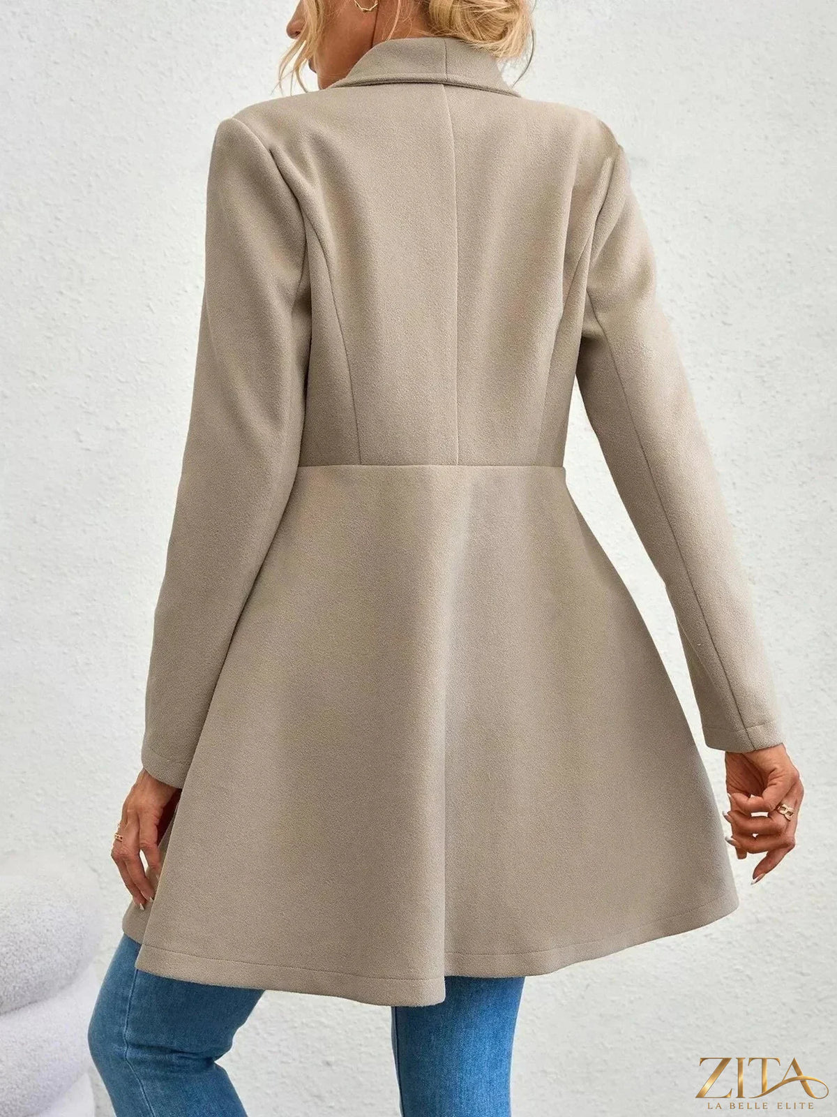 Zita La Belle Elite double-breasted wool blend coat hanging on a wooden rack, showcasing its tailored fit and classic style.