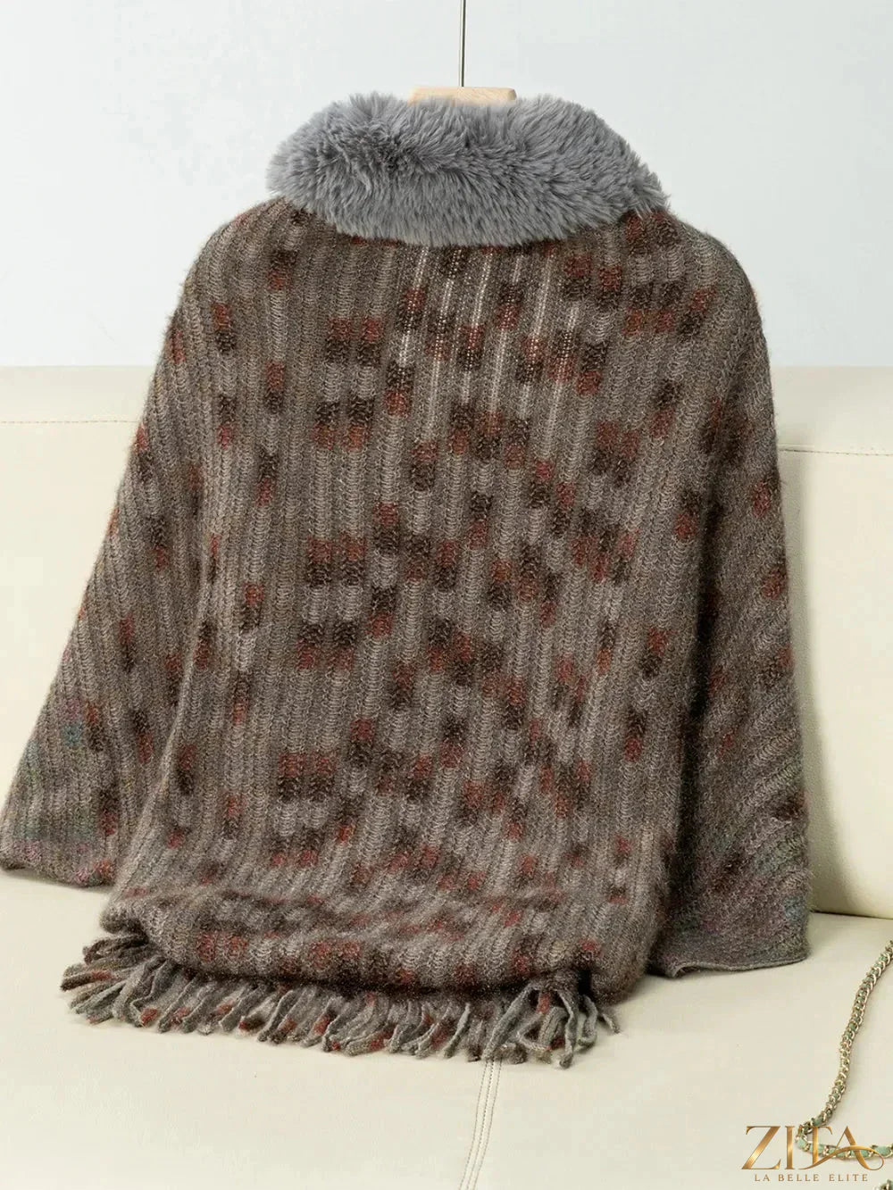 Fuzzy open front fringe poncho in neutral tones, stylish and cozy, designed by Trendsi with tassel details and layered fringe accents.