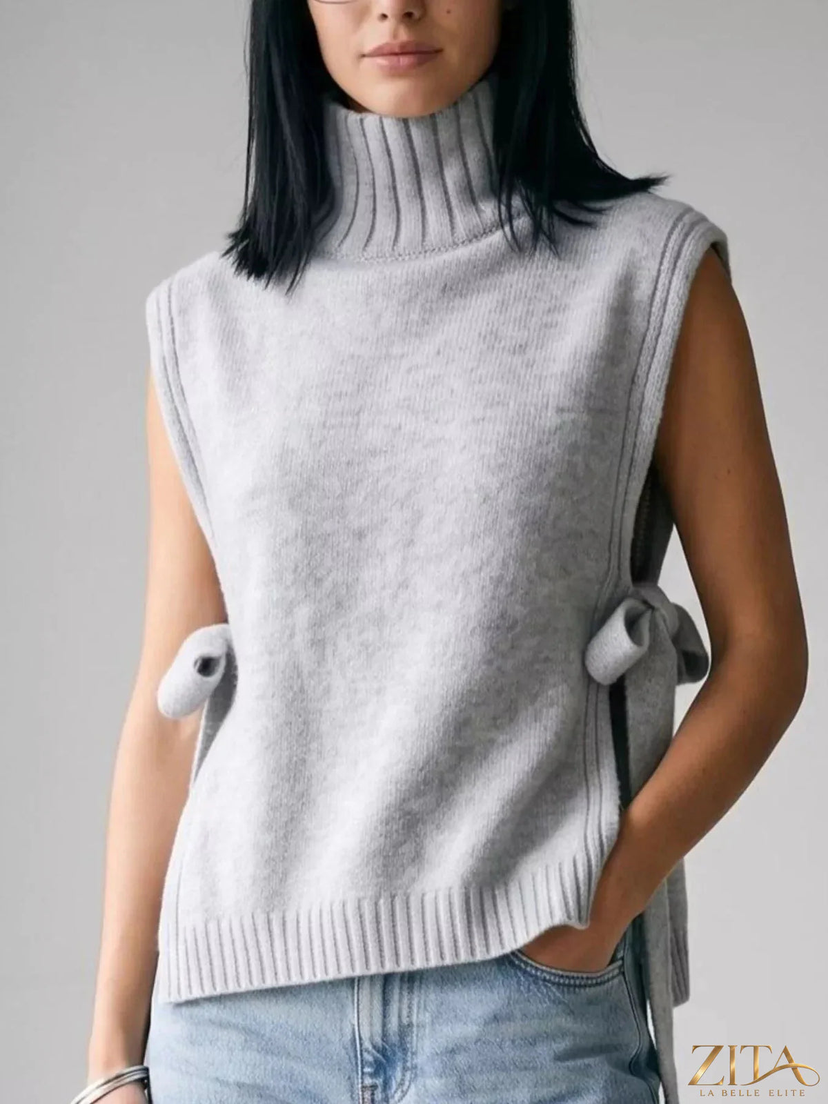 Cream turtleneck side-tie knit sweater vest from Trendsi, featuring a fitted design and stylish front tie detail.