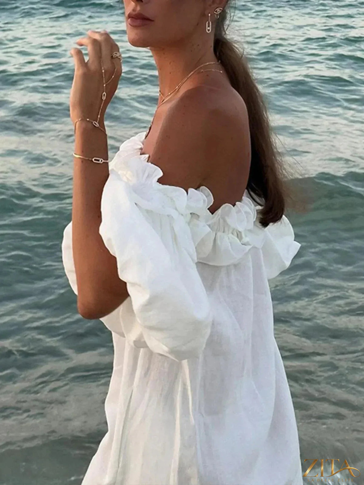 Zita La Belle Elite side slit off-shoulder dress in flowing fabric, featuring a stylish neckline and elegant design.