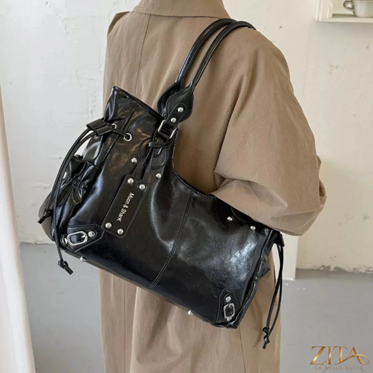 Drawstring leather handbag by Trendsi featuring a sleek design with adjustable straps and a spacious interior.