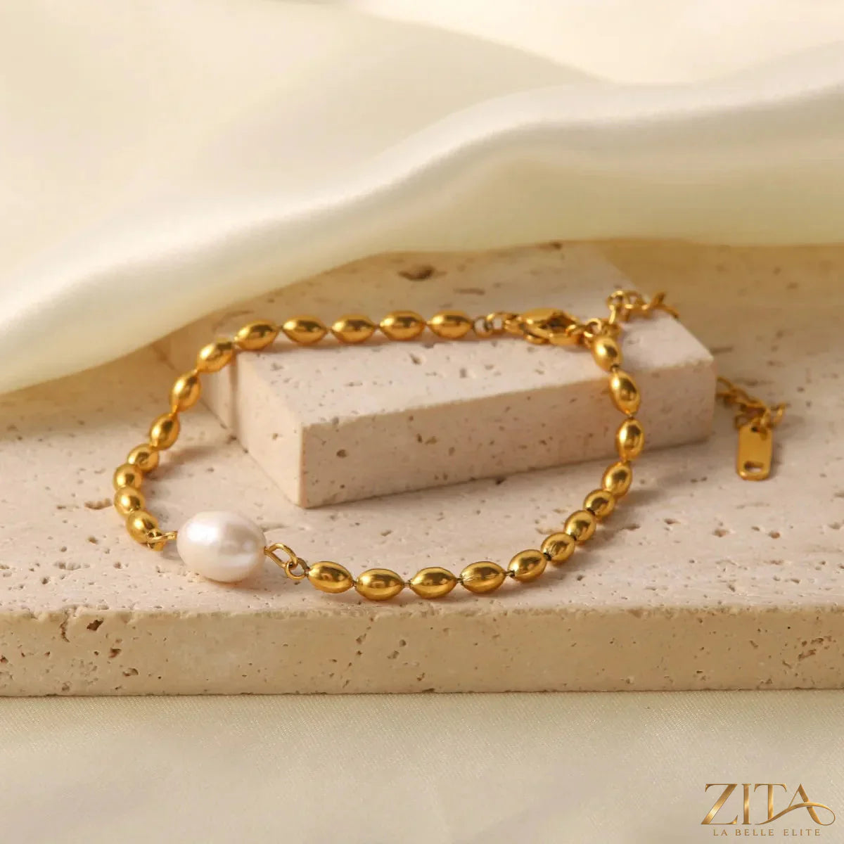 Pearl and gold chain jewelry set including a necklace and bracelet with elegant pearl accents and gold links.