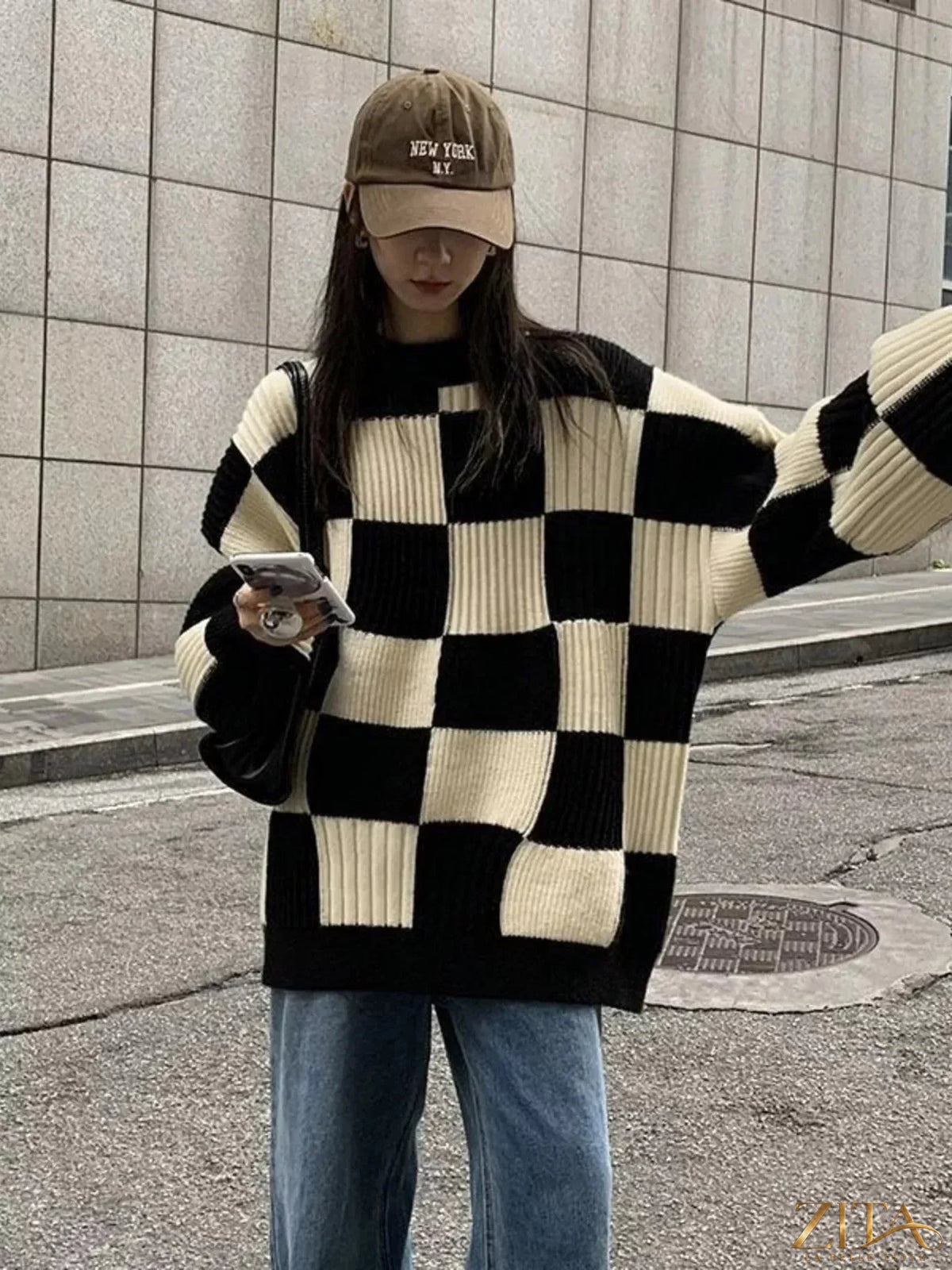 Zita La Belle Elite oversized sweater with black and white checkerboard pattern, cozy knit fabric, and relaxed fit.