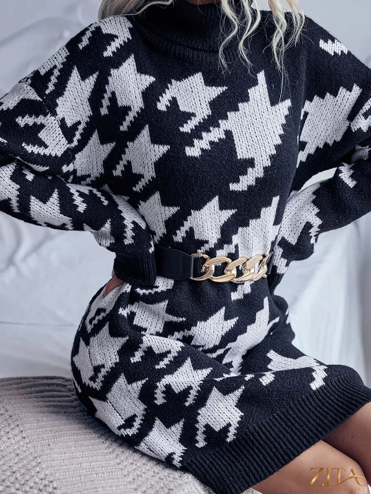 Houndstooth pattern turtleneck sweater dress from Trendsi featuring a close-up of the classic black and white knit fabric.