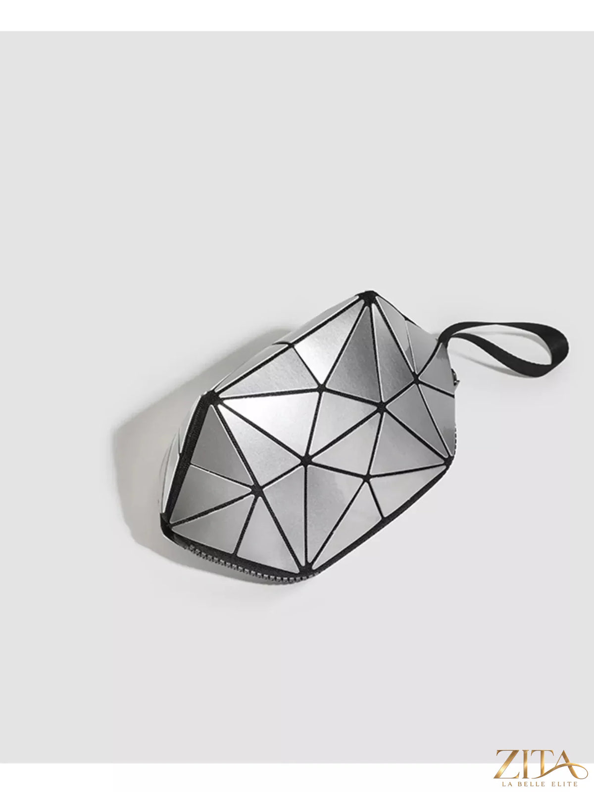 Geometric leather wristlet in neutral tones, stylish Trendsi accessory with modern geometric design and wrist strap detail.