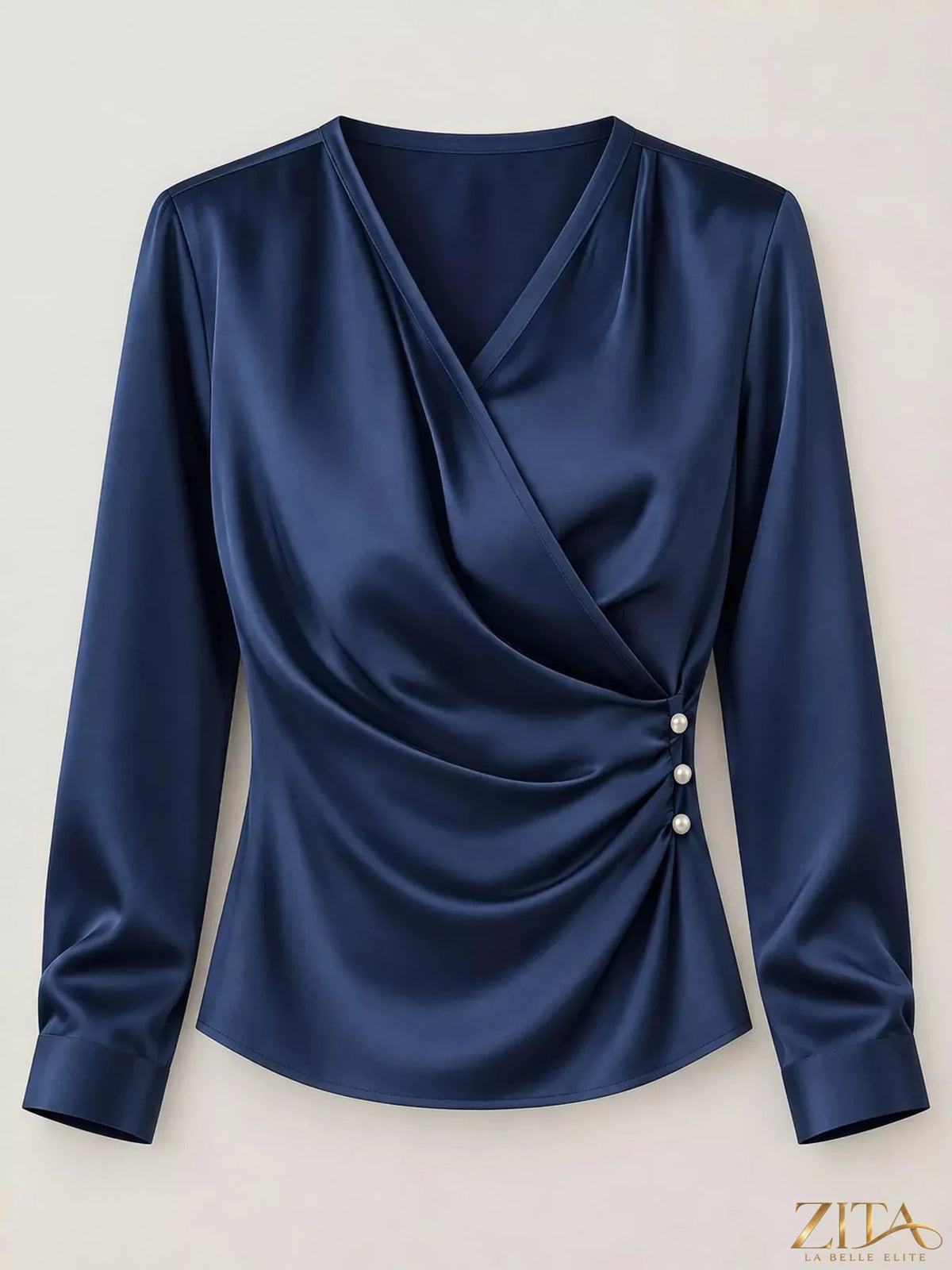 Zita La Belle Elite satin surplice long sleeve blouse with V-neck and elegant draping, displayed on a hanger against a neutral background.