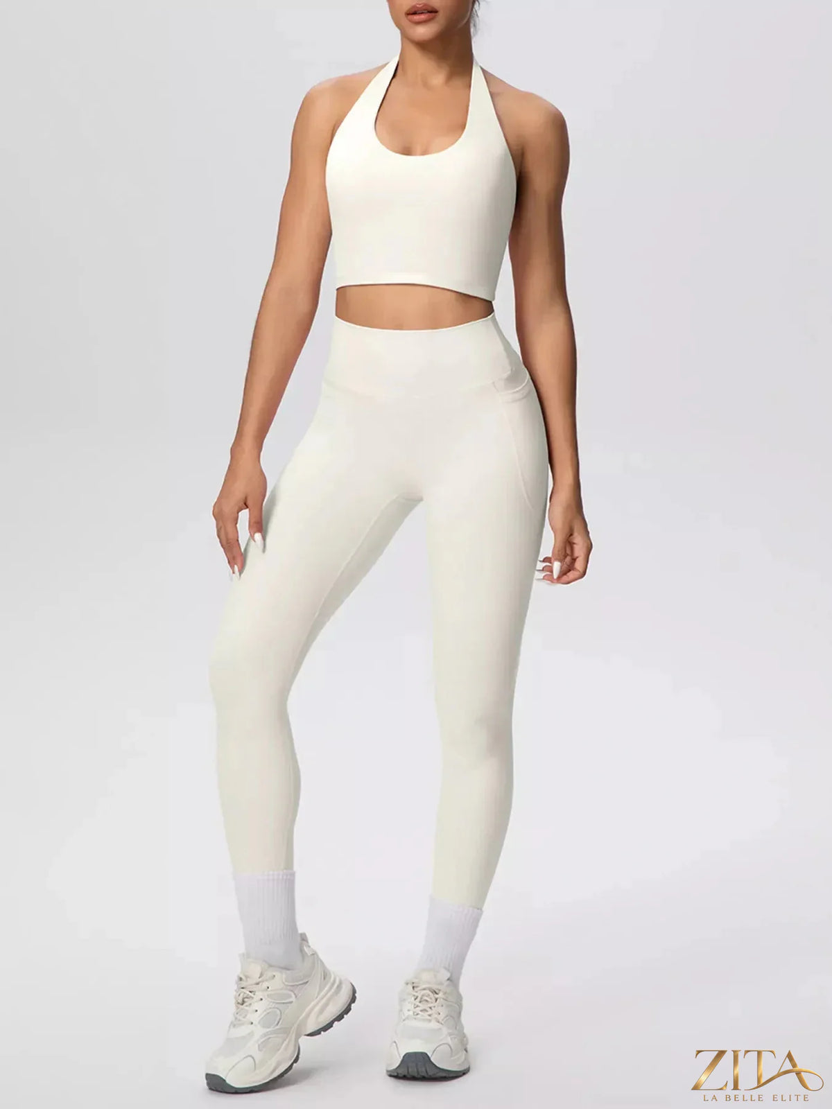 Zita La Belle Elite halter neck crop top and high-waisted leggings active set, shown in a stylish workout pose.