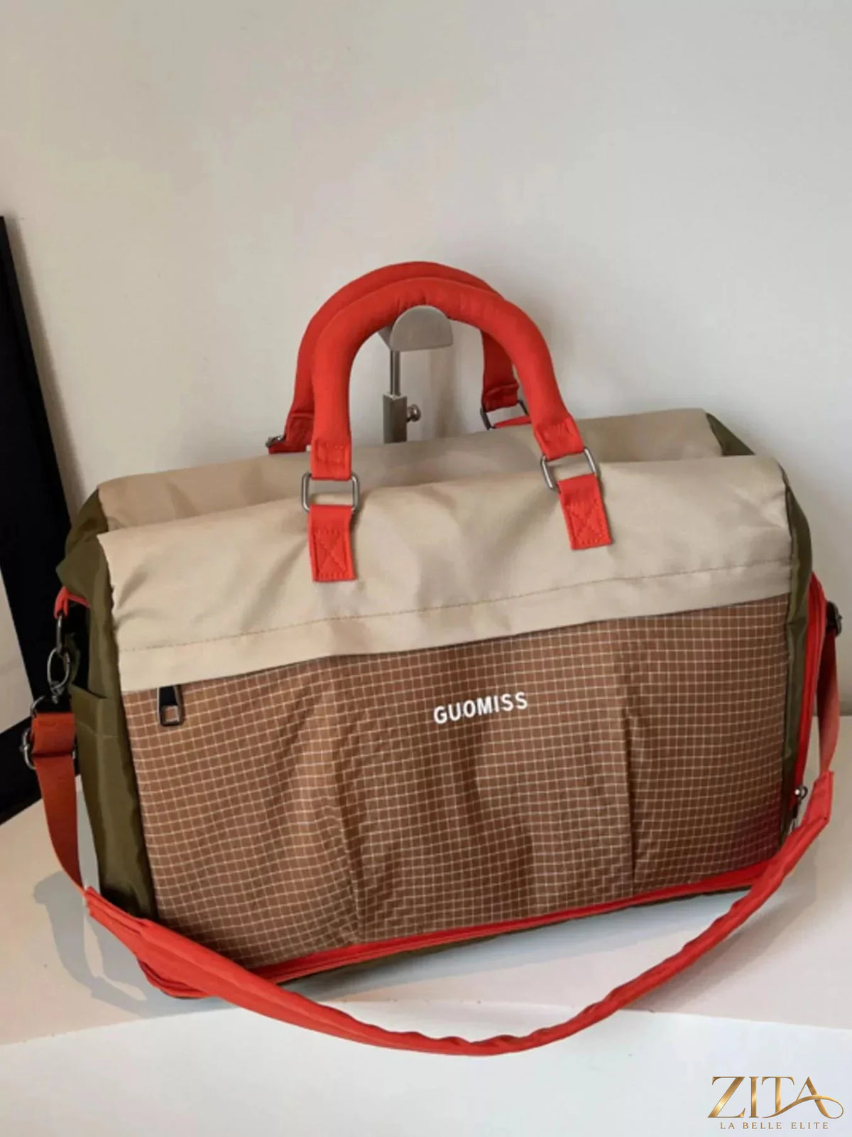 Zita La Belle Elite plaid travel bag with detachable strap, featuring a checkered pattern and sturdy handles for easy carrying.