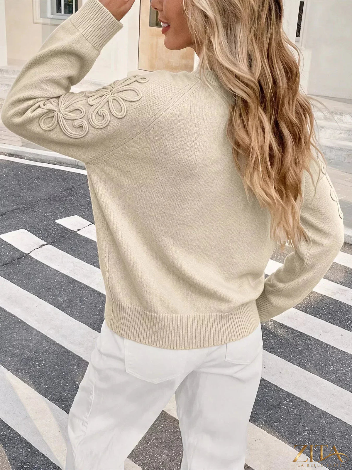 Floral raglan sleeve sweater by Trendsi featuring a cozy knit with floral patterns and contrasting sleeve colors.