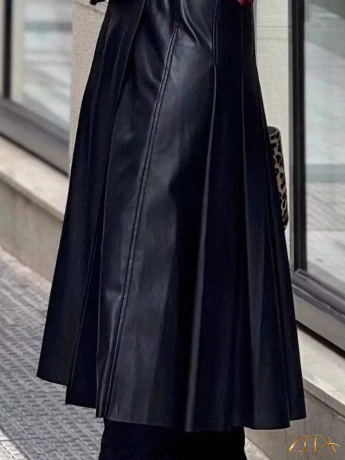 Buckle detail faux leather midi skirt from Trendsi, featuring a sleek design and fashionable buckle accents.