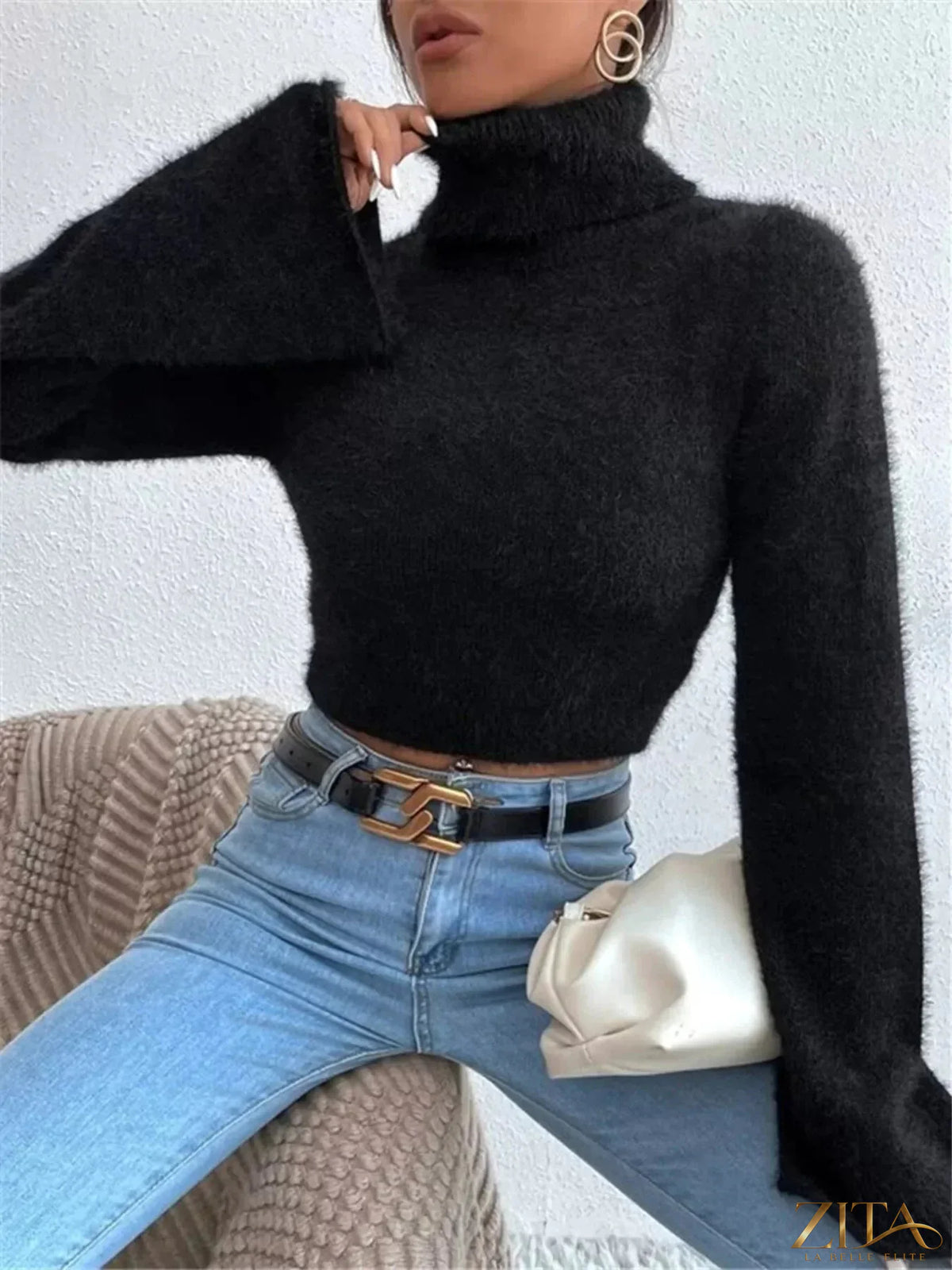 Cream-colored turtleneck sweater with flare sleeves, stylish and cozy, by Trendsi. Perfect for casual or chic winter looks.