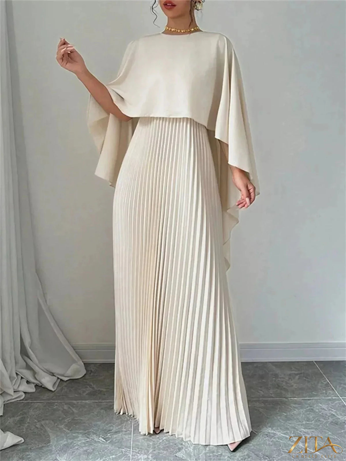 Elegant navy blue cape pleated maxi dress by Trendsi, featuring flowing fabric and sophisticated design for formal occasions.