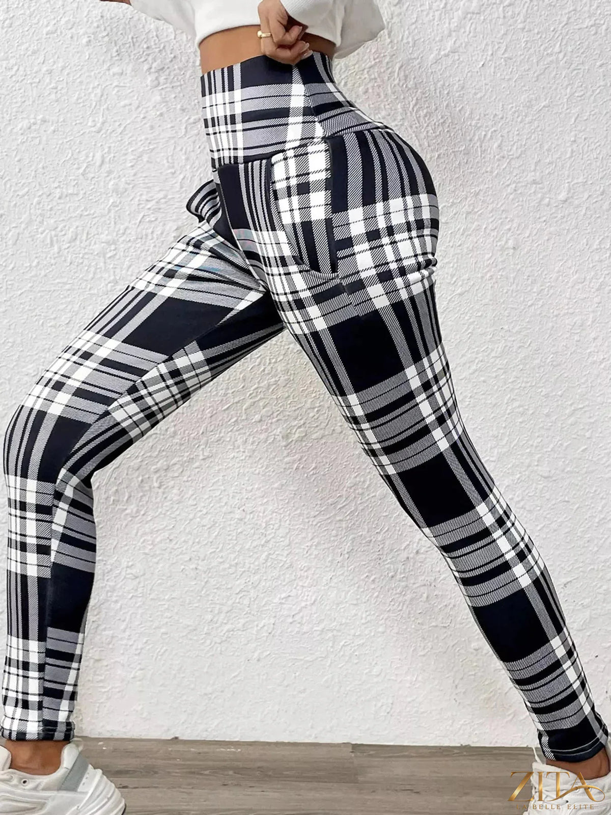 High-waisted plaid slim-fit leggings from Trendsi featuring a stylish checkered pattern and snug fit, ideal for casual wear.