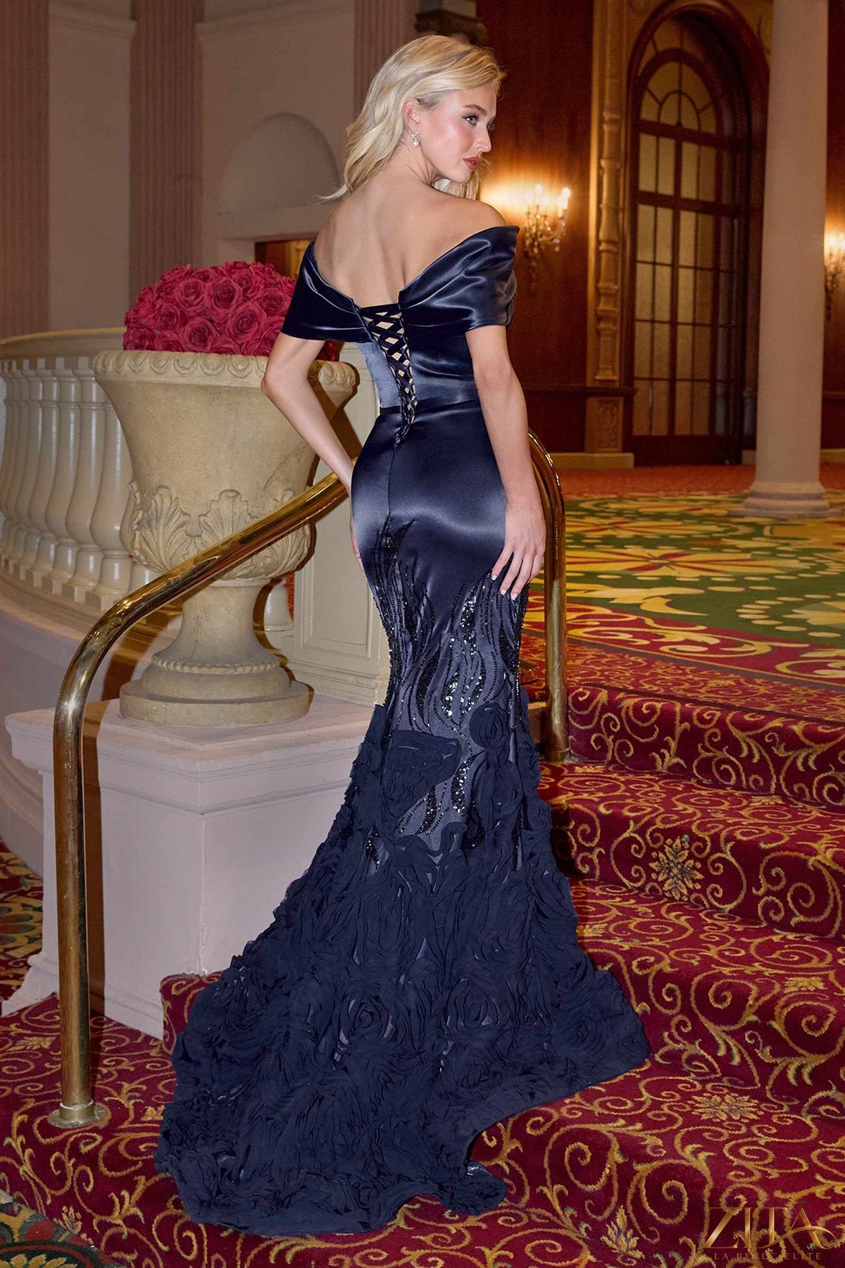 Navy satin off-the-shoulder mermaid gown by Zita La Belle Elite, flowing dress with fitted silhouette and elegant back design.