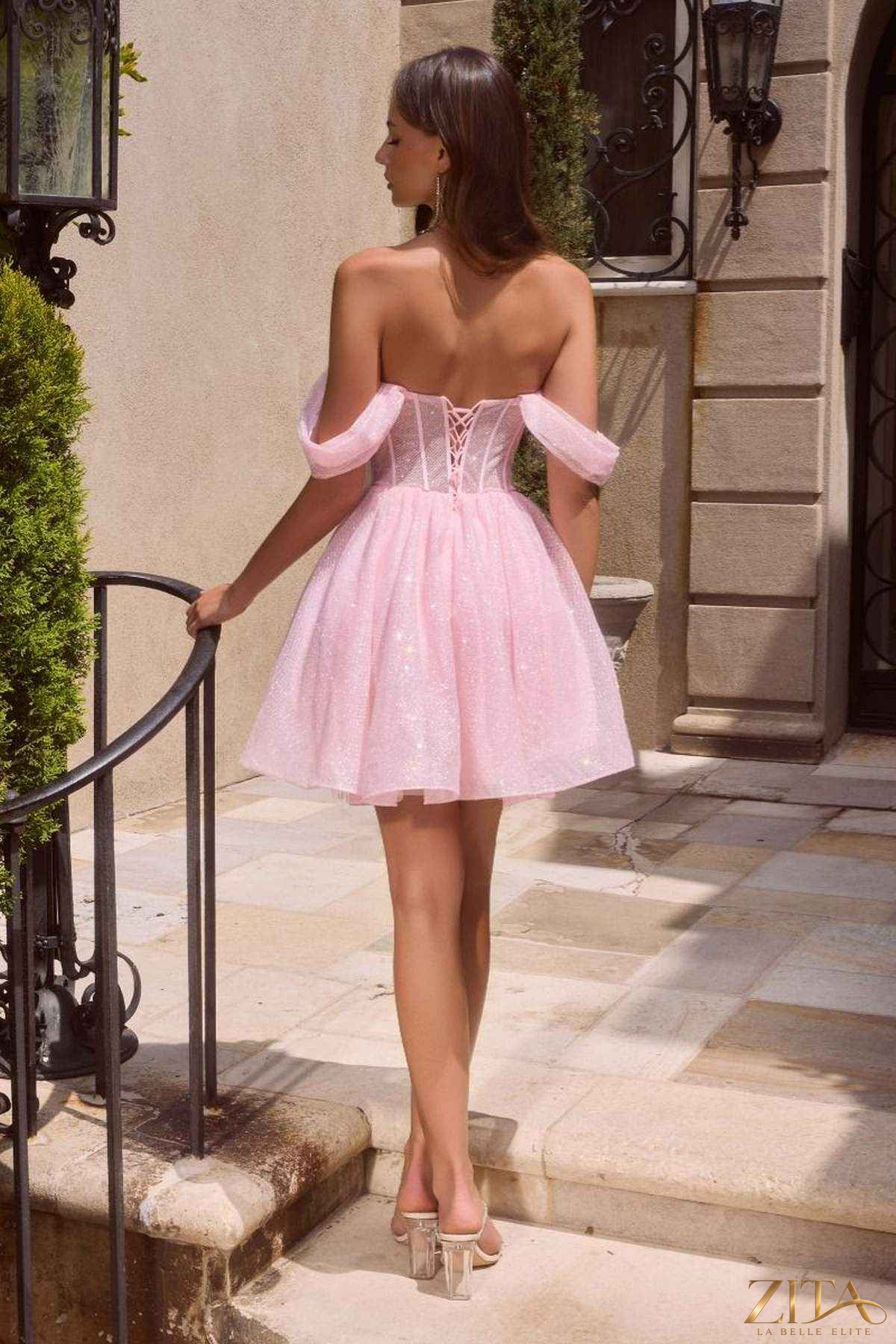 Blush off-shoulder glitter tulle short dress with corset back by Zita La Belle Elite, showcased from the back view.