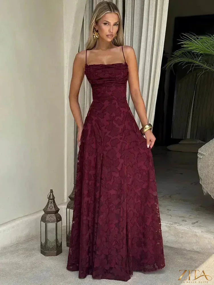 Elegant backless maxi evening dress with spaghetti straps and lace-up design by Zita La Belle Elite, suitable for formal events.