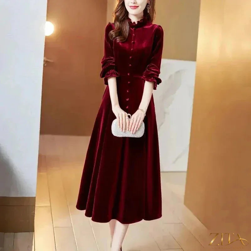 Women’s wine red velvet maxi dress with long sleeves by Zita La Belle Elite, featuring a flowing, elegant design.