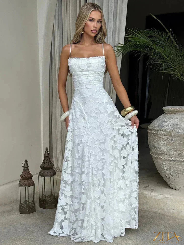 Elegant backless maxi evening dress with spaghetti straps and lace-up detail by Zita La Belle Elite, perfect for formal occasions.