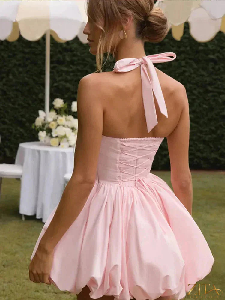Women's pink corset puffball-hem mini dress by Zita La Belle Elite, showcasing a casualwear dress with a fitted bodice and ruffled hem.