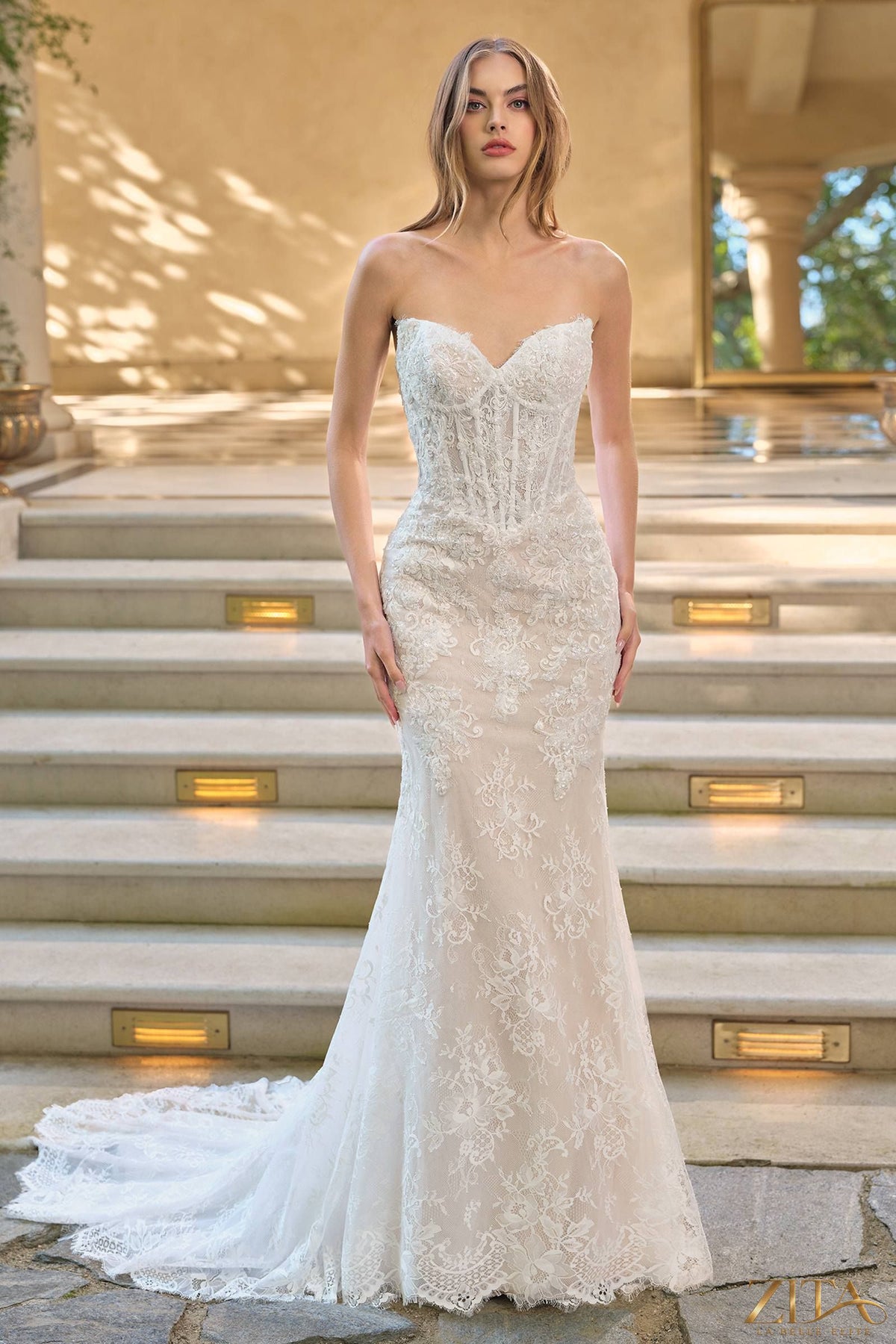 Elegant white fit and flare wedding dress with lace overlay and matching bolero jacket by Zita La Belle Elite.
