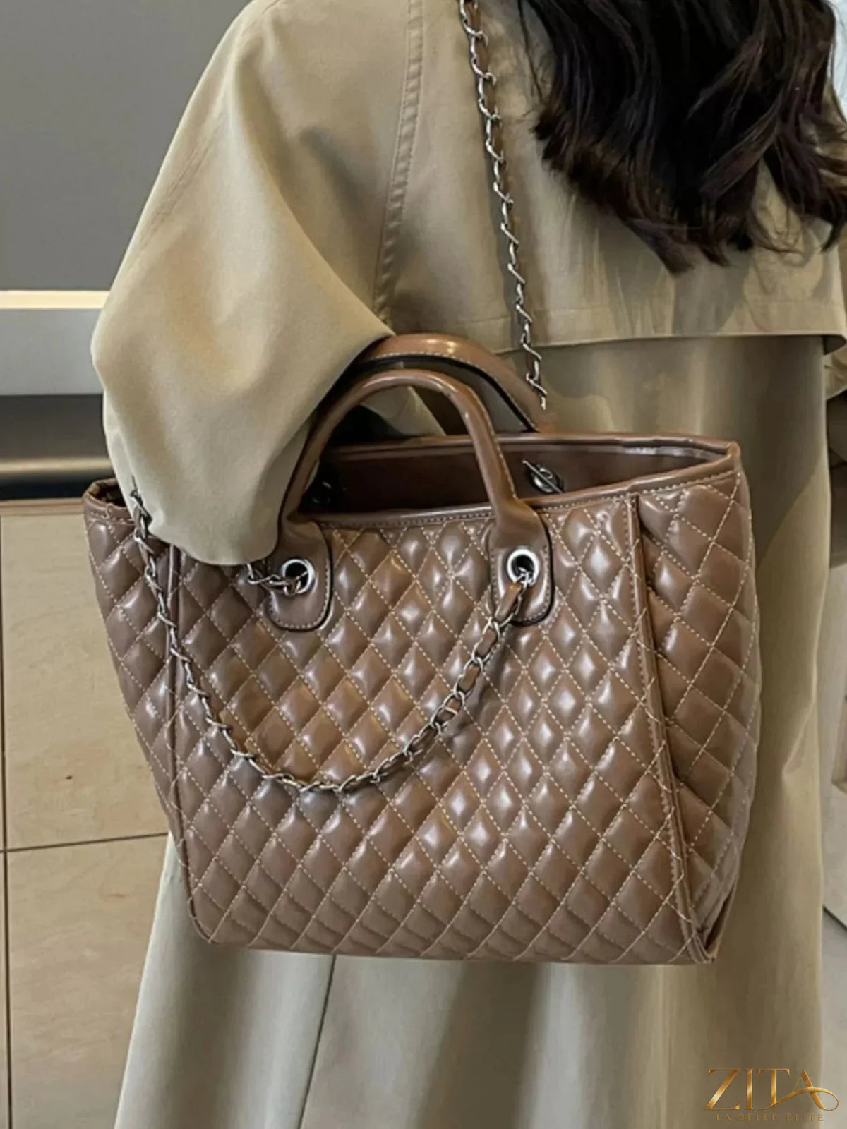 Zita La Belle Elite quilted chain shoulder bag with gold hardware and a sleek, padded design, stylishly displayed on a neutral background.