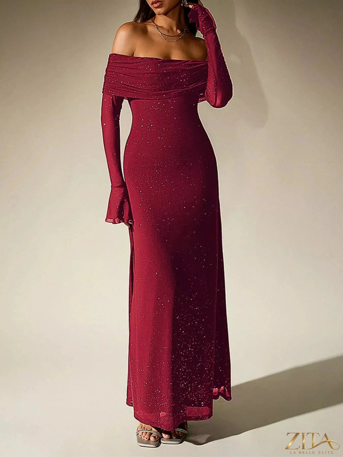 Zita La Belle Elite glitter off-shoulder maxi dress with flowing fabric and shimmering details, perfect for elegant occasions.