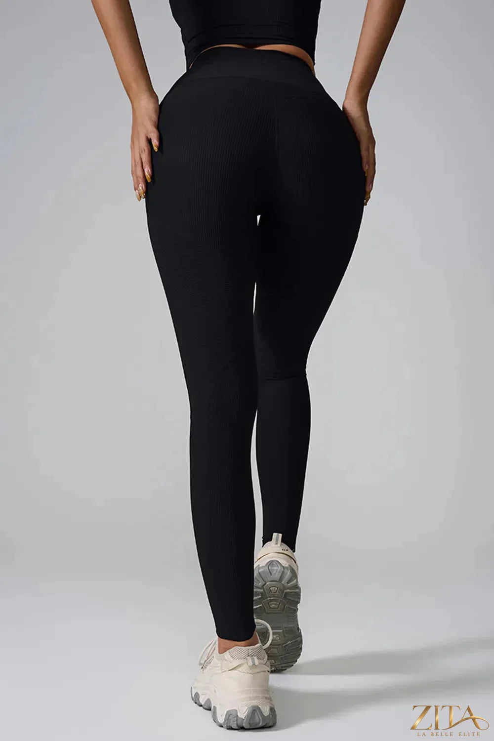 Black high-waist active leggings from Trendsi, featuring a snug fit and stretchy fabric for workout and casual wear.