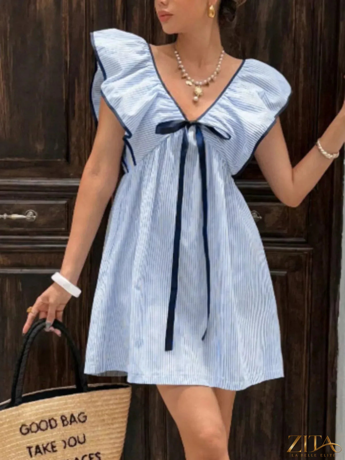Striped ruffle sleeve mini dress by Trendsi featuring a fitted silhouette and playful ruffle details on the sleeves.