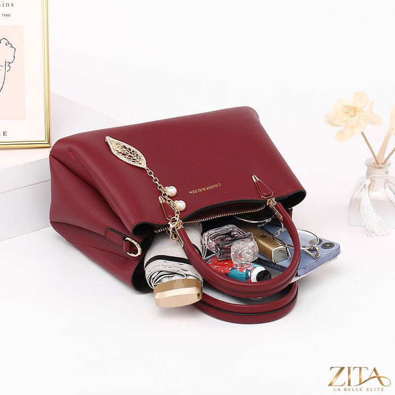 Zita La Belle Elite top-handle leather handbag with gold hardware and structured design, featuring a sleek, polished look.