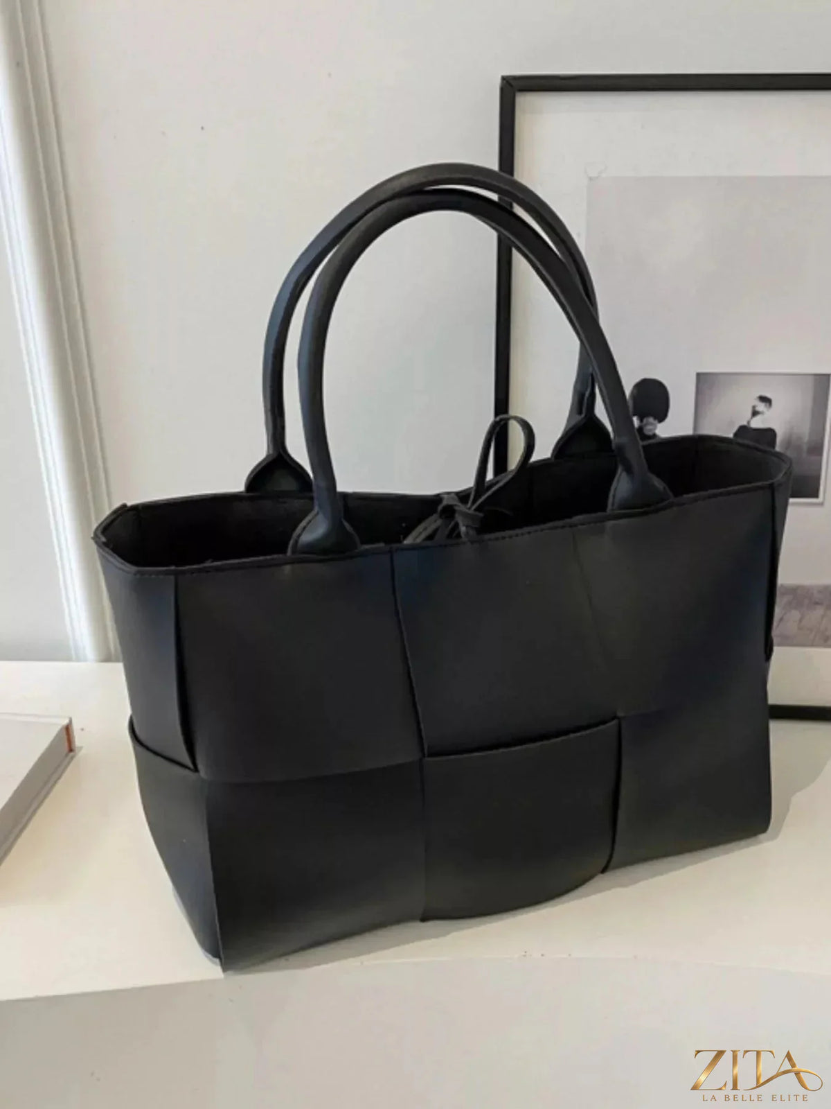 Woven leather tote bag by Zita La Belle Elite with sturdy handles and intricate woven design, perfect for everyday use.