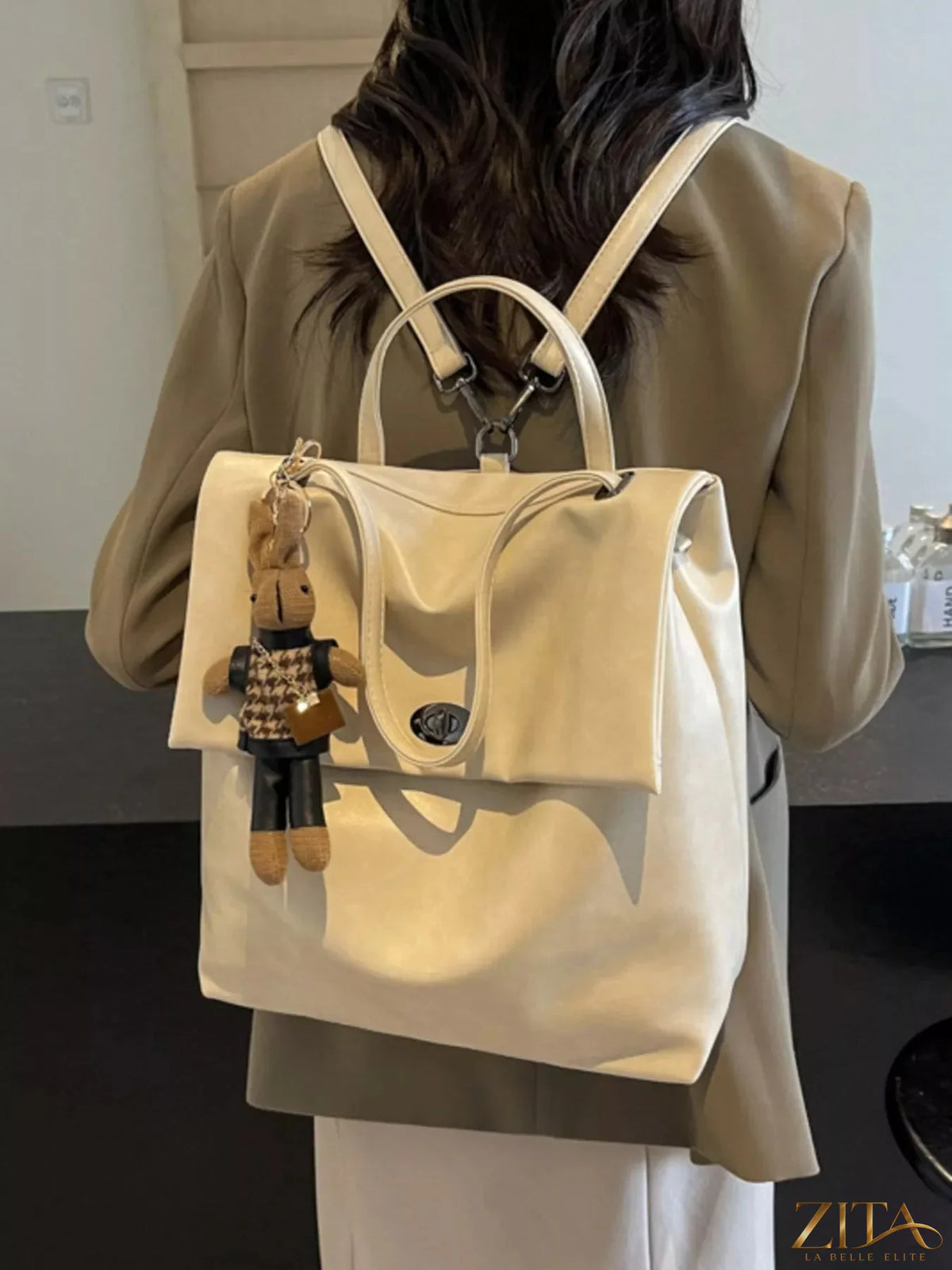 Leather flap backpack bag from Trendsi featuring a sleek design, adjustable straps, and a spacious main compartment.