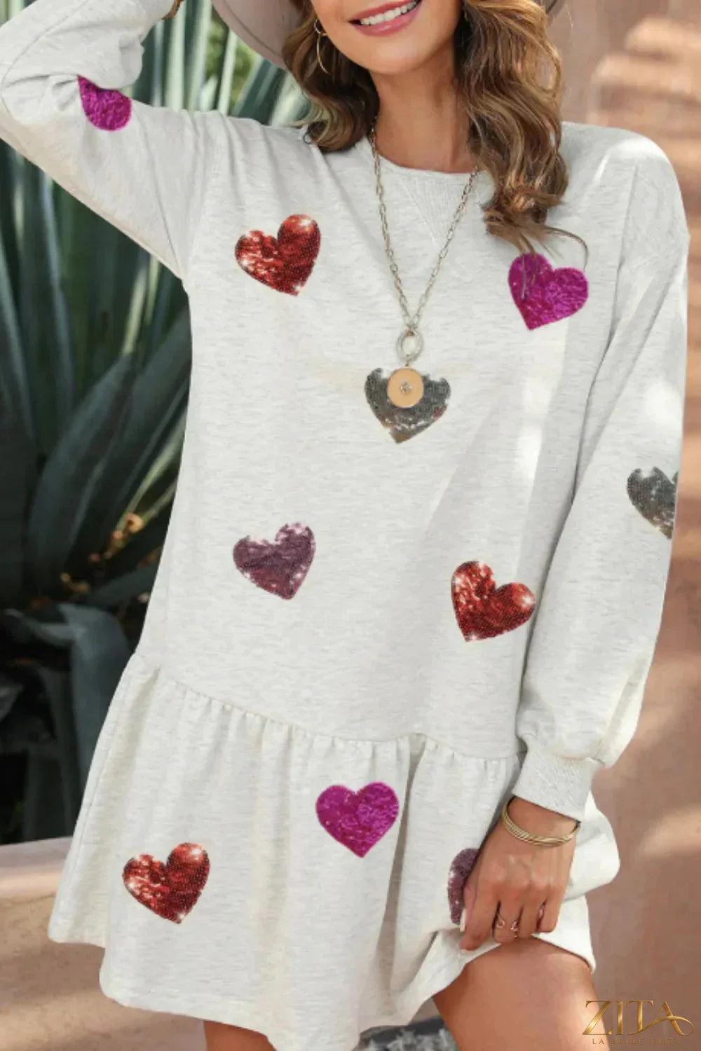 Zita La Belle Elite sequin heart round neck long sleeve mini dress, stylish and shiny with a fitted silhouette and playful heart detail.