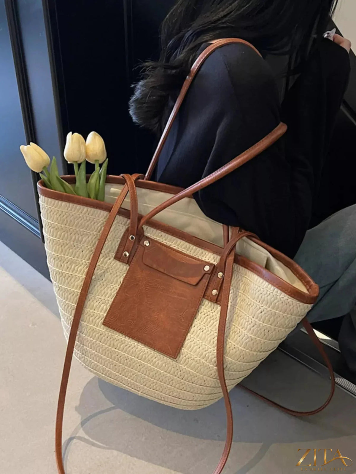 Woven straw tote bag by Zita La Belle Elite, featuring natural straw material, sturdy handles, and spacious interior for everyday use.