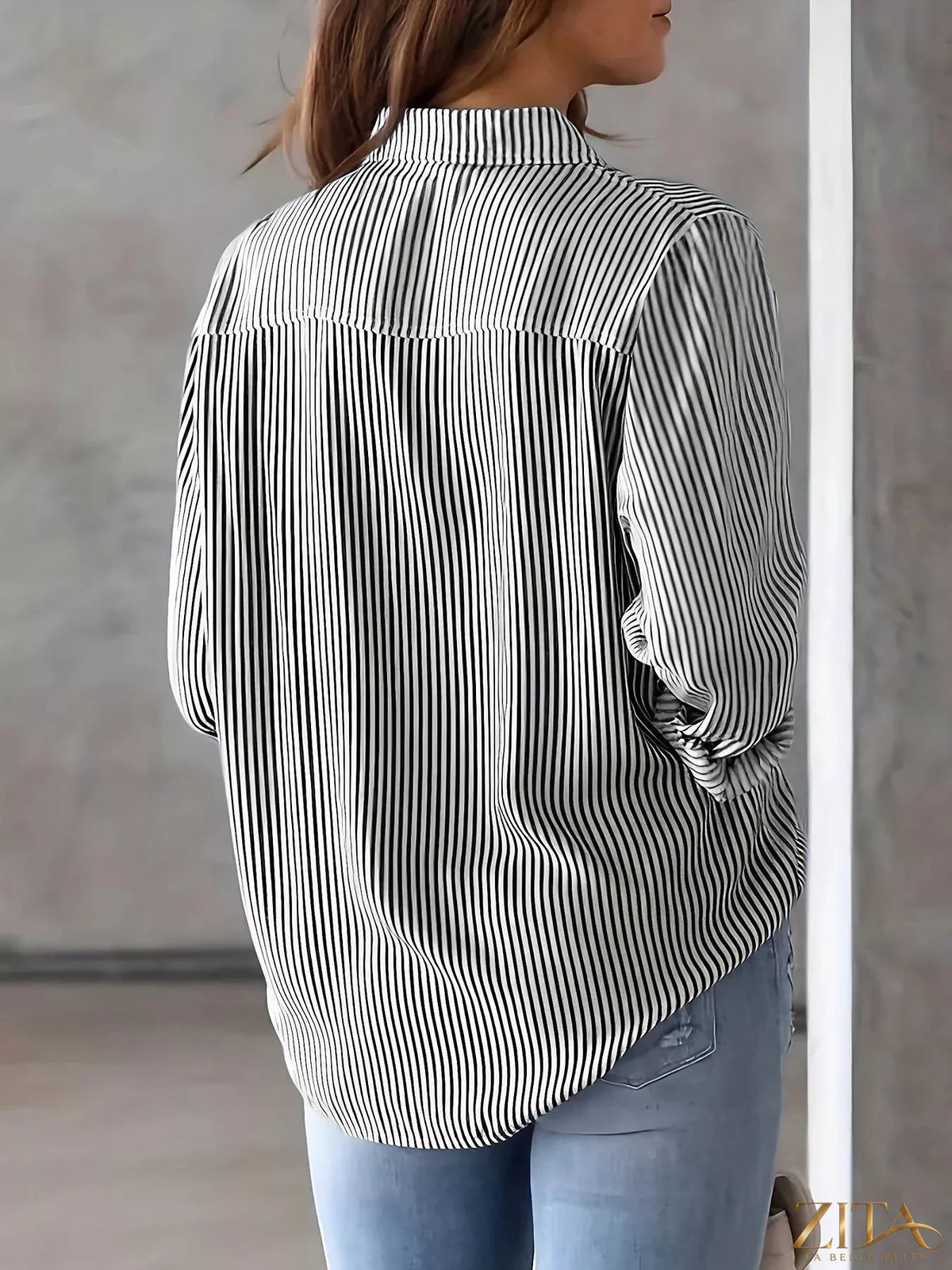 Zita La Belle Elite classic striped button-down shirt with blue and white vertical stripes, folded on a wooden surface.