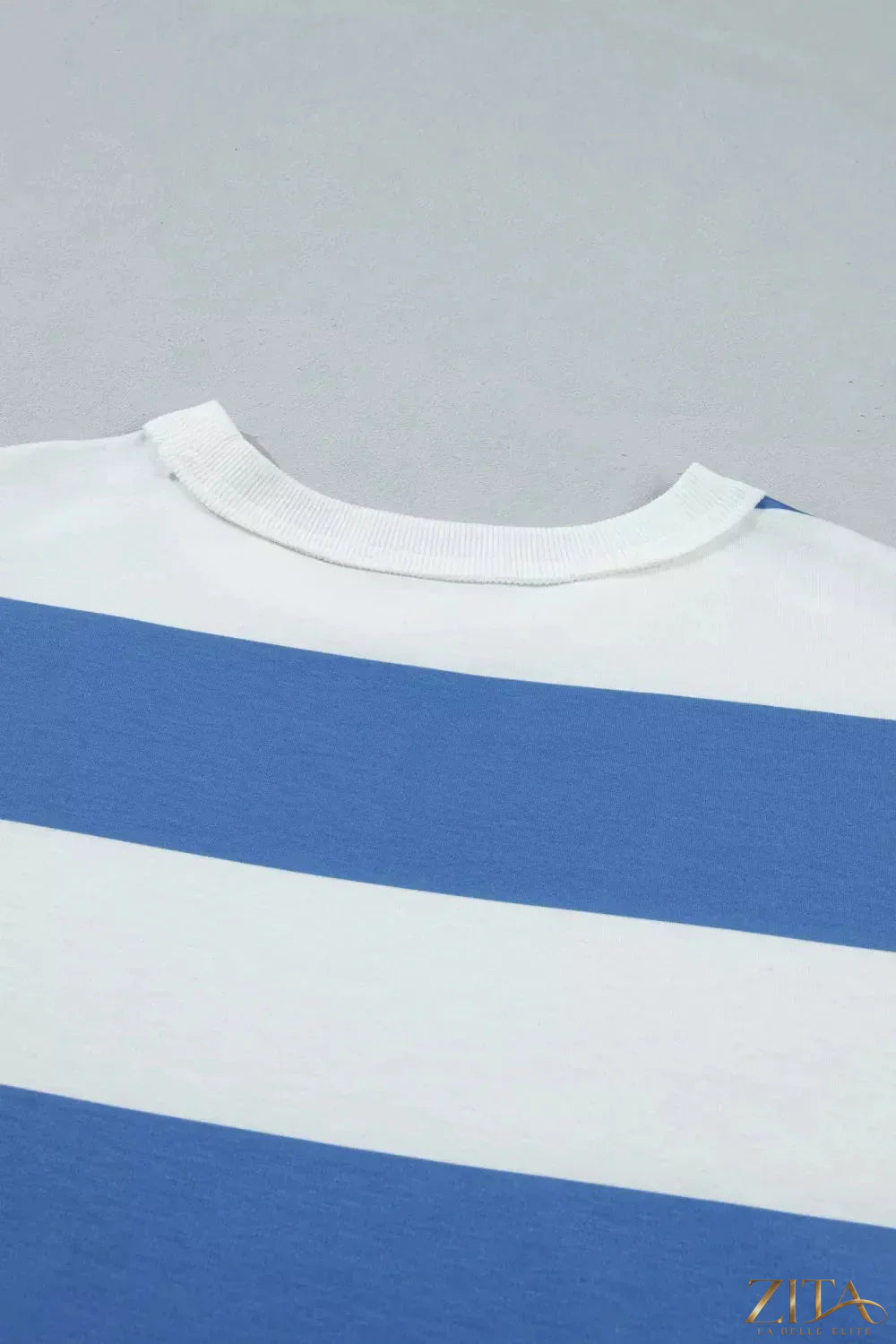 Zita La Belle Elite casual striped T-shirt dress displayed on a hanger, featuring a relaxed fit and colorful horizontal stripes.