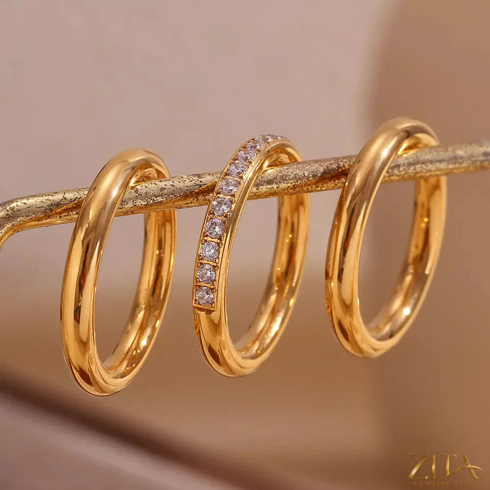 Set of three stainless steel zircon rings from Zita La Belle Elite, featuring shiny, polished bands with sparkling zircon stones.