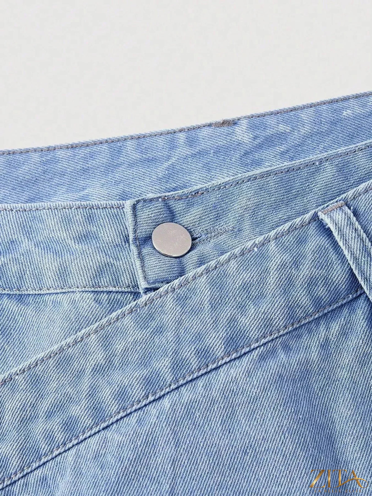 Zita La Belle Elite asymmetric raw hem wide-leg jeans displayed, featuring a stylish, relaxed fit with unique uneven hem details.
