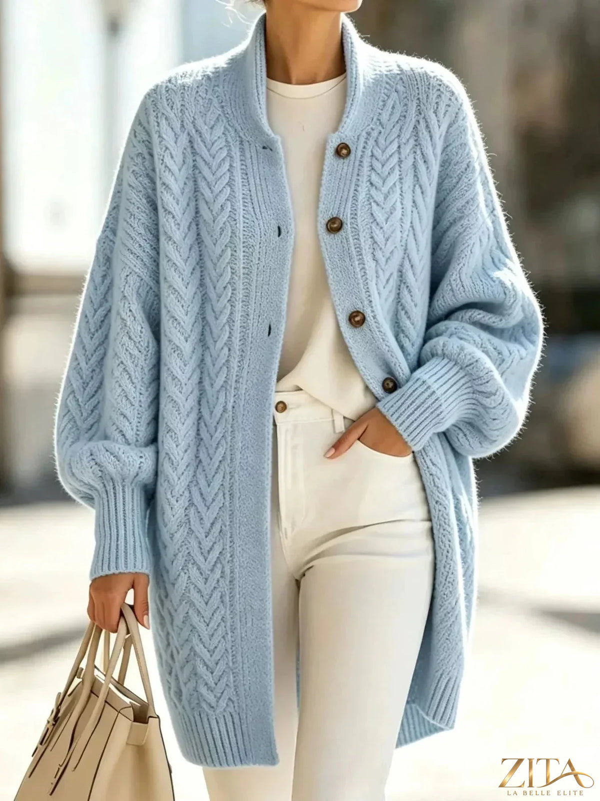 Plus size Zita La Belle Elite cable-knit button-down cardigan displayed on a model, showing its cozy, full-length design.