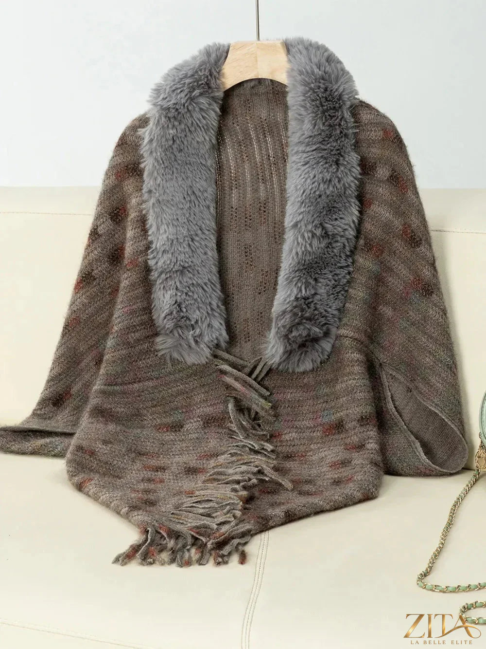 Fuzzy open front fringe poncho by Trendsi featuring soft texture and stylish design, displayed on a mannequin.