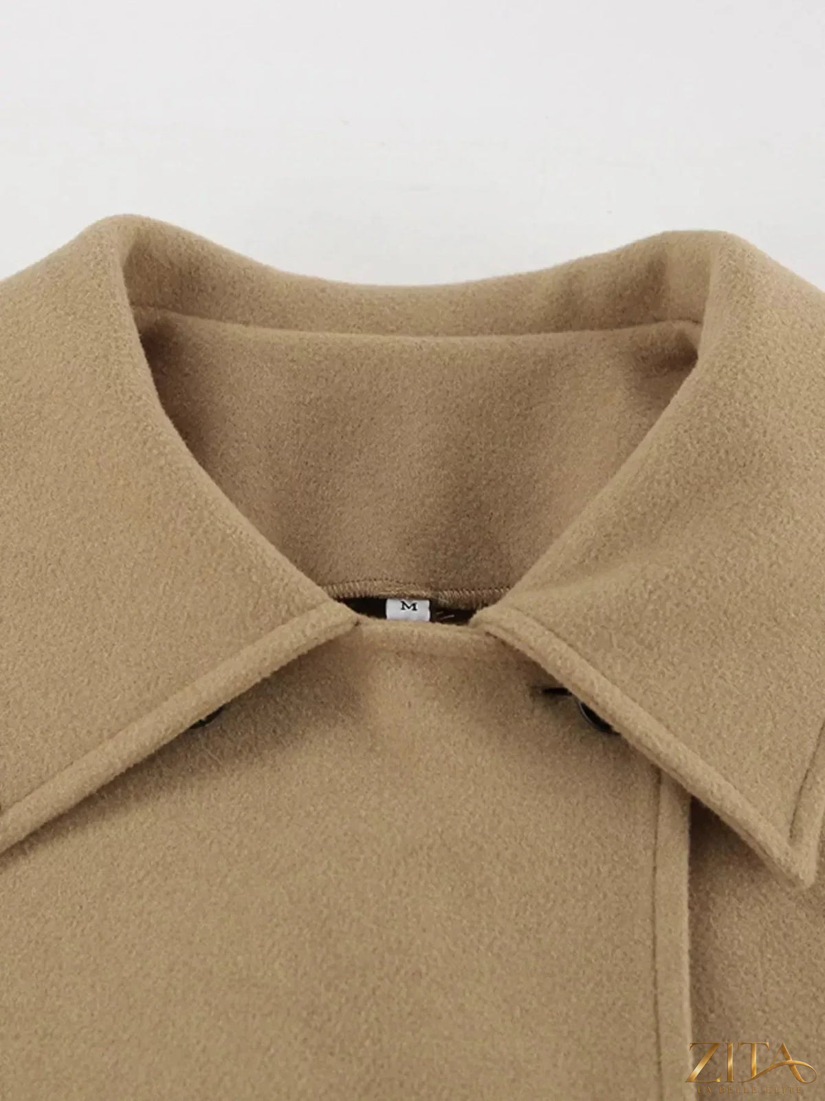 Zita La Belle Elite oversized lapel collar button-down coat hanging on a wooden rack with a neutral background.