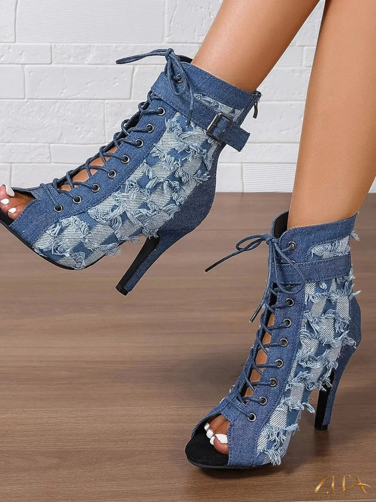 Distressed denim lace-up peep toe ankle boots by Zita La Belle Elite with rugged design and stylish cutouts.