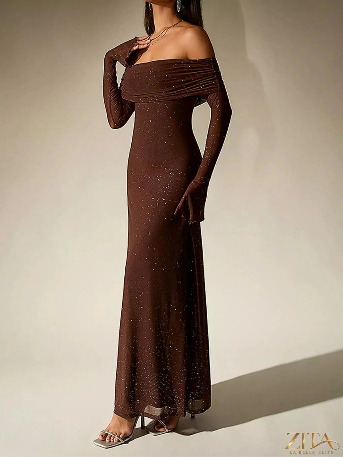 Zita La Belle Elite glitter off-shoulder maxi dress featuring shimmering fabric and a flowing silhouette, perfect for elegant occasions.