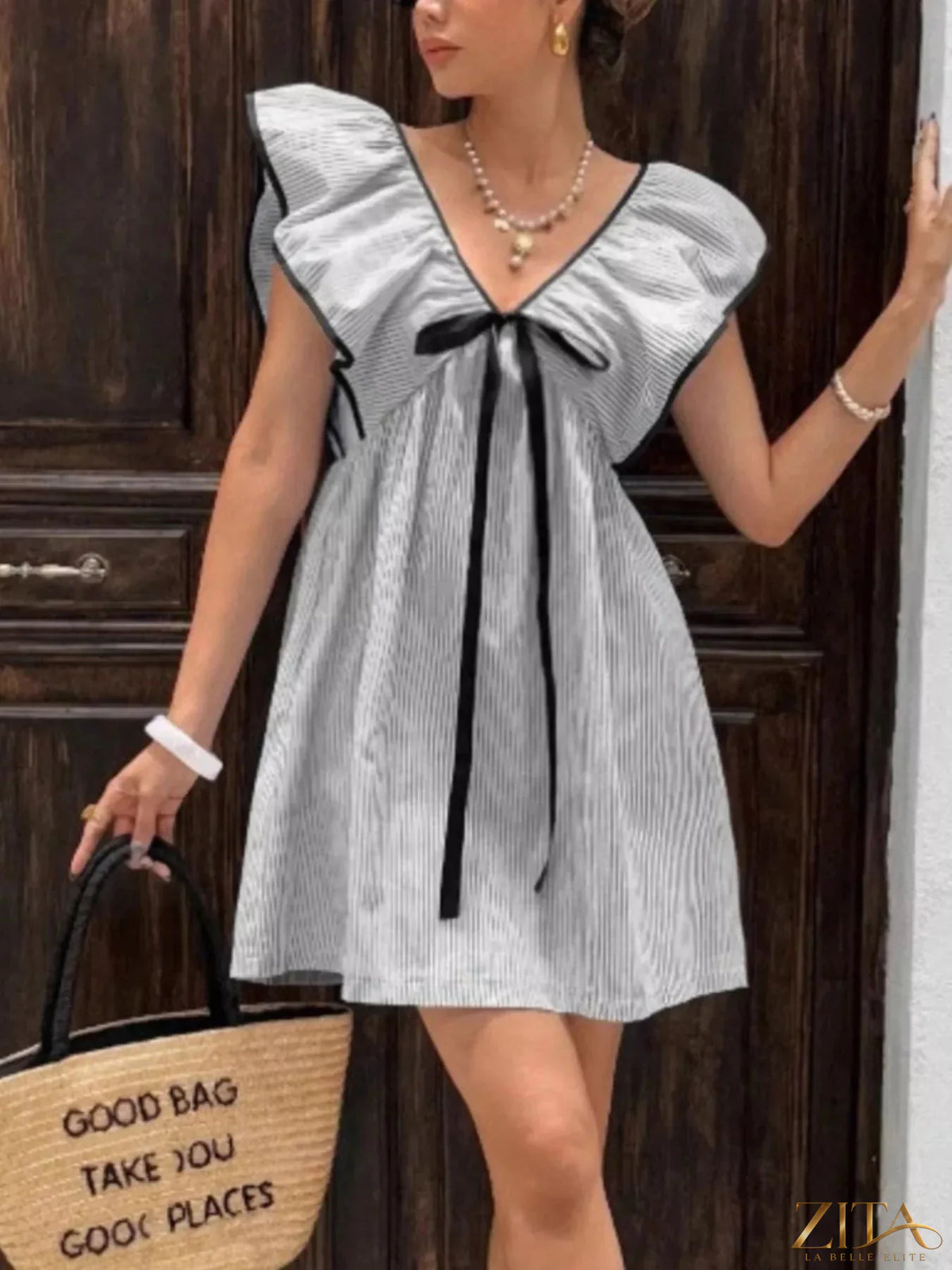 Striped ruffle sleeve mini dress by Trendsi featuring a fitted bodice, playful ruffle sleeves, and a stylish mini length.